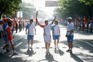 Meena with the Olympic torch; from the torch relay head of the Beijing Olympics